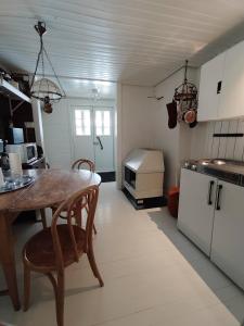 a kitchen with a wooden table and a counter top at Villa Puharila in Längelmäki