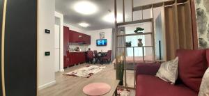a living room with a red couch and a kitchen at Karp Studio in Sinaia