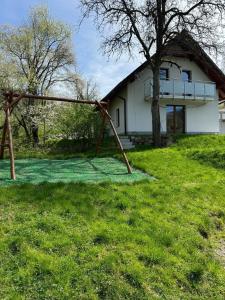 a swing set in front of a house at Domek na Skarpie in Wisła