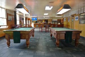 two pool tables in a room with a bar at Okoroire Hot Springs Hotel in Okoroire