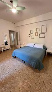 a bedroom with a bed and a ceiling fan at Primo Piano in Moneglia