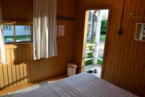 a bedroom with a bed and an open door at Villa Puharila in Längelmäki