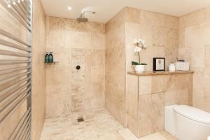 a bathroom with a shower and a toilet at Garden Apartment - Close to Town Centre - sleeps 6 in Buxton