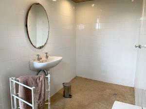 a bathroom with a sink and a mirror at Hillhouse Accommodation in Howick