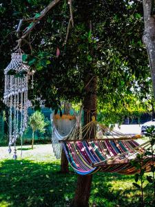 a hammock hanging from a tree in a park at MAYANA SICILY - The suites in Santa Maria Del Focallo