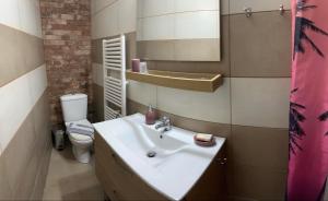 a bathroom with a sink and a toilet at πετρινη κατοικια in Vári +4 photos