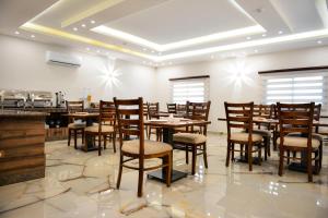 a dining room with wooden tables and chairs at Petra Premium Hotel in Wadi Musa