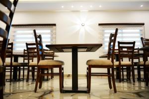 a dining room with wooden tables and chairs at Petra Premium Hotel in Wadi Musa