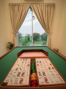a pool table in a room with a window at 16pax+Ninja's SweetHome Seremban in Seremban