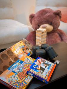 a teddy bear sitting next to a table with presents at 16pax+Ninja's SweetHome Seremban in Seremban