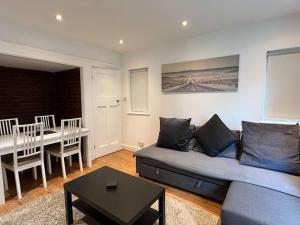 a living room with a couch and a table at 3 Bed luxury house, 10 min walk to underground in London