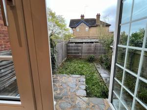 a view of a yard from a window at 3 Bed luxury house, 10 min walk to underground in London