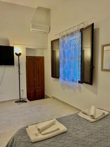a room with a bed with a blue curtain and a window at Marsala al centro n9 in Marsala