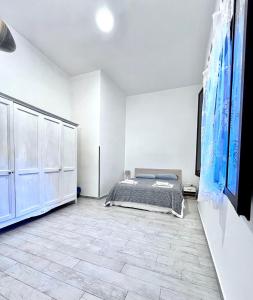 a bedroom with a bed and a tiled floor at Marsala al centro n9 in Marsala