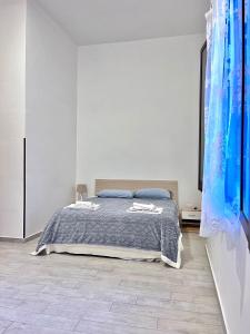 a bedroom with a bed in a white room at Marsala al centro n9 in Marsala
