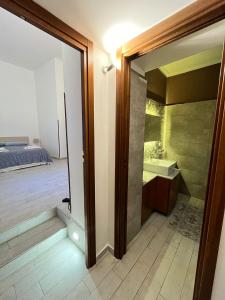 a bathroom with a glass door leading to a bedroom at Marsala al centro n9 in Marsala +27 photos