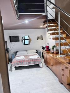 a bedroom with a bed and a staircase in a room at Marsala al centro n 9 in Marsala