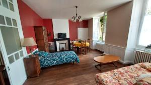 a living room with a couch and a table at Les Gites du château in Châteaumeillant