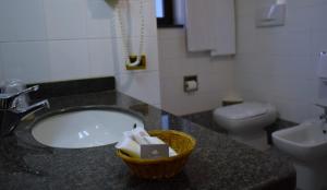a bathroom with a sink and a toilet at Hotel 90 in Capurso