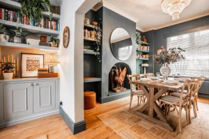 a dining room with a table and chairs at Arkles - Victorian Gem in Liverpool