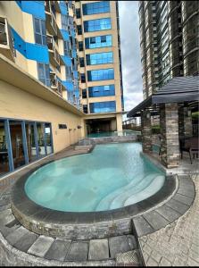 a large swimming pool in front of a building at Grand Riviera Suites in Manila