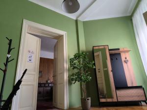 a hallway with a mirror and a potted plant at Konzul in Osijek