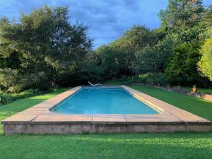 a swimming pool in the middle of a yard at Hillhouse Accommodation in Howick