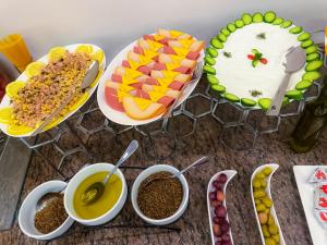 a table with plates of food and cups of coffee at Petra Premium Hotel in Wadi Musa