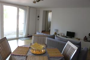 a living room with a table and a couch at Studio charmant au calme in Aix-en-Provence