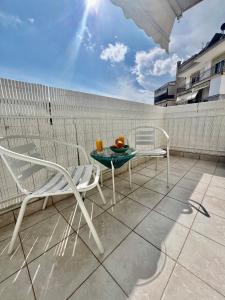 a patio with a table and chairs on a balcony at City lux apartment 2 in Serres