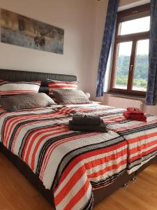 a bedroom with a bed with a striped blanket at Loreleyquartier in Sankt Goarshausen