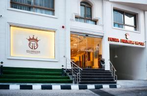 a store front with stairs in front of a building at Petra Premium Hotel in Wadi Musa