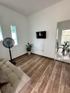 a living room with a couch and a table at Casa Maresia in Saquarema