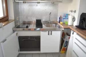 a small kitchen with a sink and a stove at Zentrale Eigentumswohnung + kostenlosem Parkplatz in Sindelfingen