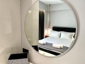a bedroom with a bed in front of a mirror at Urban Suite in Heraklio