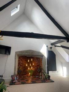 a living room with a brick fireplace in a building at Epic Location, Views & Large Private Terrace in Windsor