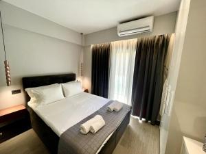 a bedroom with a bed with two towels on it at Aelia Urban Suite in Heraklio Town
