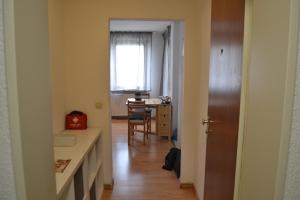 a hallway with a room with a desk and a window at Zentrale Eigentumswohnung + kostenlosem Parkplatz in Sindelfingen