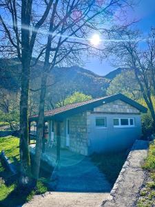 a house with a garage with mountains in the background at Tina in Cetinje +5 photos