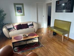 a living room with a couch and a chair at L'Ancrage in Saint Malo