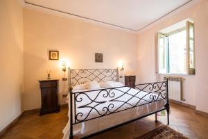 a bedroom with a metal bed in a room at Villa Carla, a charming villa in the center of Taormina in Taormina