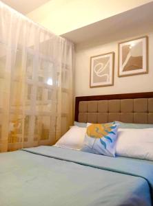 a bedroom with a bed and a window with curtains at LD Cozy Condo Unit - BE Residences near Cebu IT Park in Cebu City
