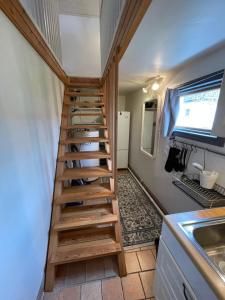 a staircase in a tiny house with a kitchen at Lilla Saturnus in Ljungskile