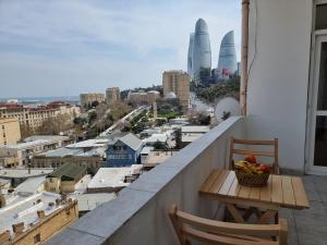 a balcony with a table and a view of a city at Central sea view in Baku