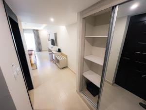 a room with a walk in closet and a living room at Petra Premium Hotel in Wadi Musa