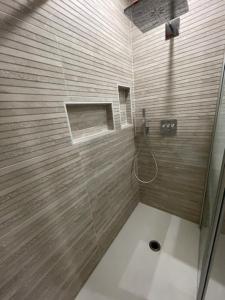uma casa de banho com um chuveiro e uma porta de vidro em Maison cosy avec piscine em Saleilles
