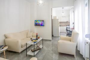 a living room with a couch and a table at House & Garden in Kavála