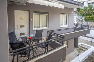 a balcony with chairs and a table on it at House & Garden in Kavála
