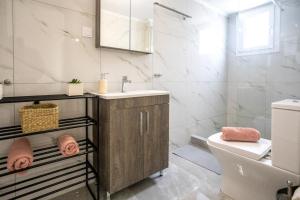 a bathroom with a sink and a toilet at House & Garden in Kavála +22 photos