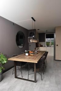 a kitchen and dining room with a wooden table and chairs at Private room in Hundvåg in Stavanger